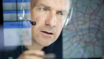 mature logistics call handler planning a route

** graphics interface self generated **